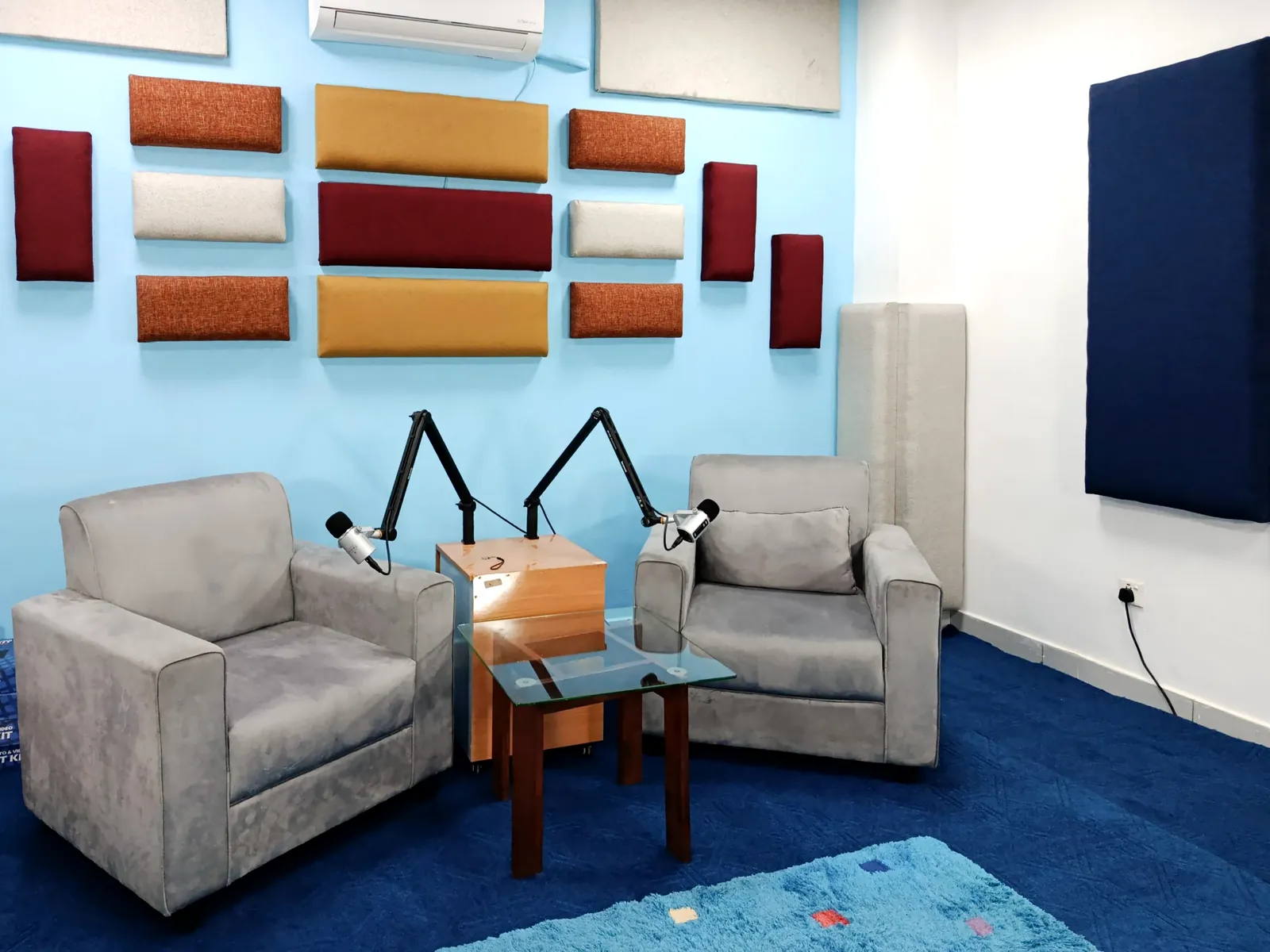 Podcast room with fabric acoustic wall panels by Sound Krafted