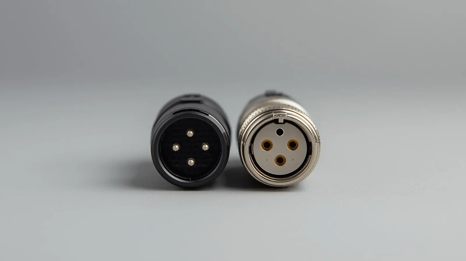 A simple photo showing a 3-pin XLR male and female connector side by side, on a neutral background
